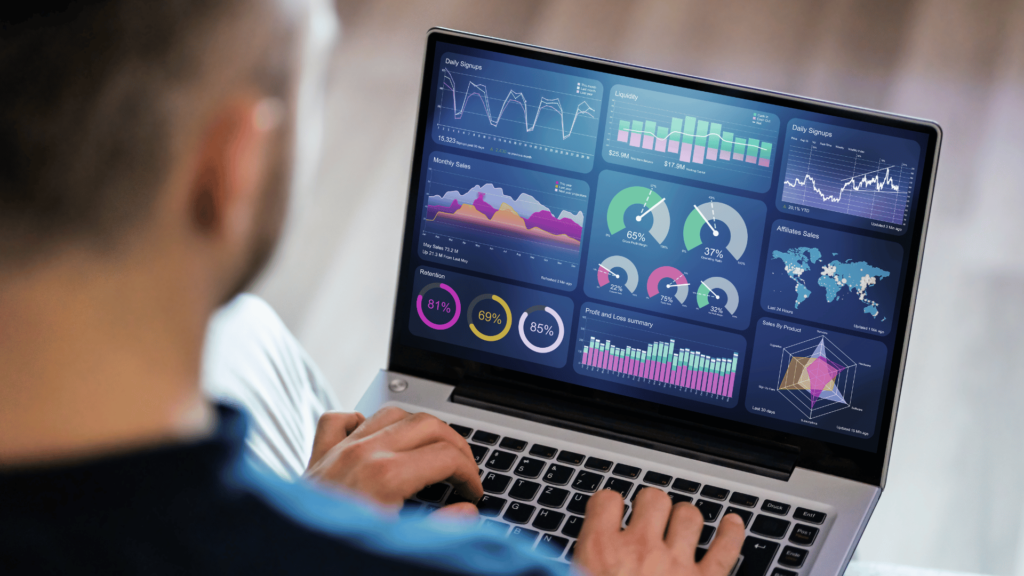 a man on a laptop working on a dashboard